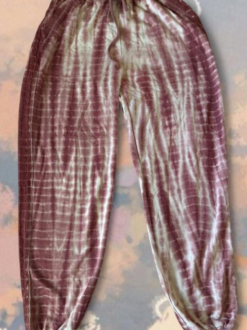 Pink tie-dye lounge pants with drawstring waist and pockets